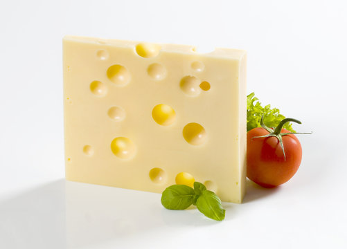 Slice of hard cheese and a tomato