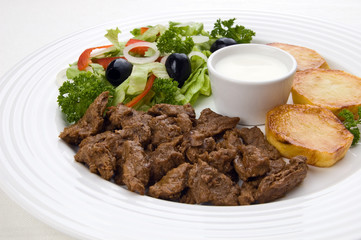 Grilled meat with baked potatoes and vegetable salad