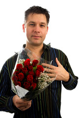 Young man in love is giving red roses over white background