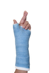 Blue cast on broken wrist or arm with fingers crossed for luck