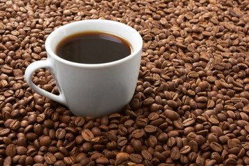 Cup with coffee, costing on coffee grain