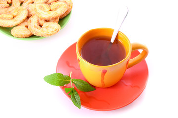 Cup of green tea on the saucer with mint.