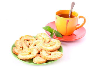 Cup of green tea on the saucer with mint.