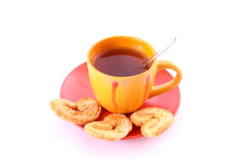 Cup of green tea on the saucer with cookies.