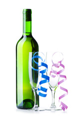 Bottle of wine and glass with streamer on white