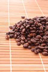 Coffee grains on brown background.