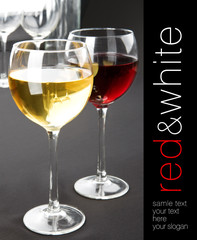 Two glasses of white and red whine. Grey background