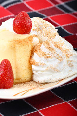 Fresh strawberry on top of vanilla pudding dessert