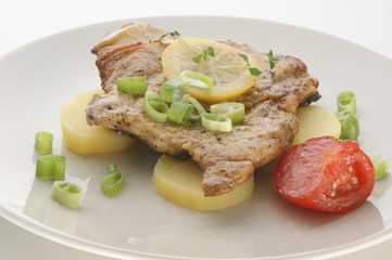 carp steak with potato and tomato