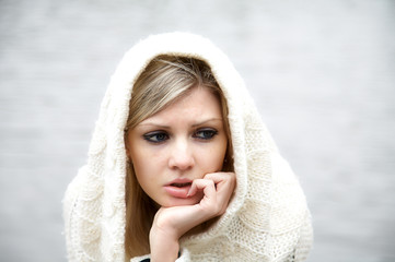 Obraz premium The thoughtful girl in knitted dress