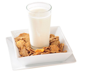 Glass of milk on portion of cereal