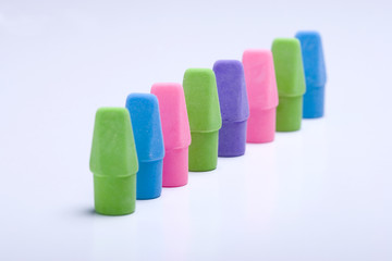 Erasers set diagonally on white background.