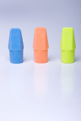 Three pencil top erasers.