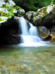 Fototapeta na wymiar waterfall in the middle of wood