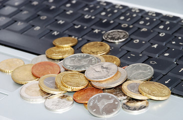 Many coins in one place on laptop keyboard