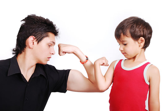 Young male model is showing muscles to little boy