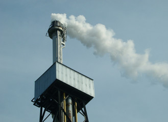 pipe of industrial processing enterprise with smoke