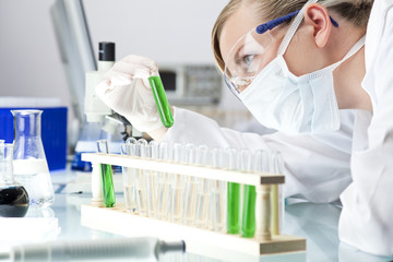 Female Scientist or Doctor With Green Solution In Laboratory