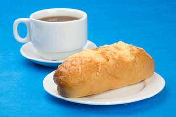 Sweet(rich) roll with cheese and cup tea.