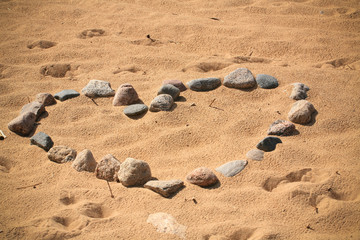 Fototapeta na wymiar Stones on hearts form on beach