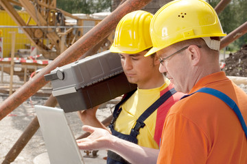 two workers on a construction site