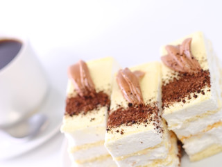 Sponge cakes on plate with coffee. Fragment. Isolated