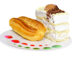 Sponge cakes on plate with fruit spots and cup of coffee.