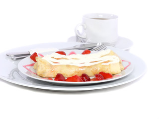 Pankcake with rolled fruit inside and strawberry around.