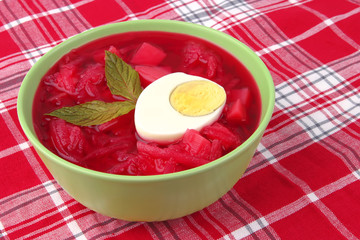 fresh beet vegetable soup in green bowl