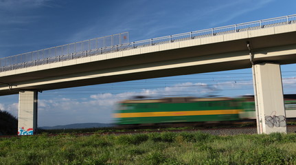 Fast train passing under a bridge