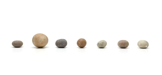 row of seven pebbles, one larger than the others