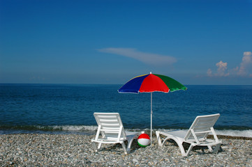 Chaise lounges and umbrella on a beach