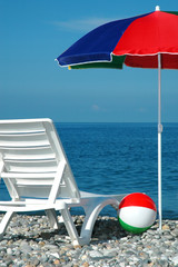Chaise lounges and umbrella on a beach