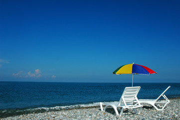 Chaise lounges and umbrella on a beach