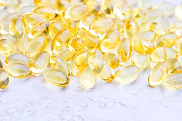 Macro of gel vitamin pills on a counter top. Shallow DOF.