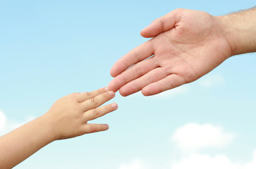 hands of the child and adult