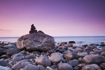 Beautiful coast sun-dawn. Piling of rocks.