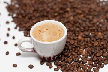 Coffee cup with beans over white background.