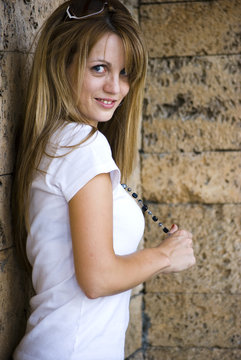 beautiful young woman posing on wall