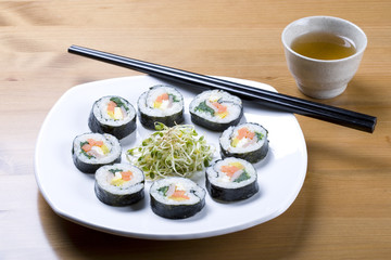 Cup of tea and Korean sushi called Kimbap.