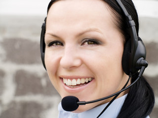 smiling brunette woman with headphone