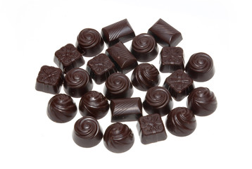 Delicious dark chocolate pralines isolated on white.