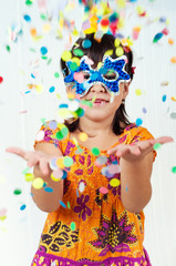 Obraz na płótnie Canvas little girl throws confetti celebrating
