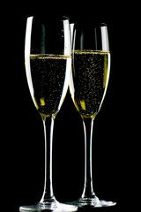 Two glasses champagne on black