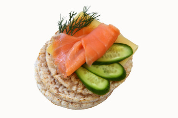 thin rice cakes with smoked salmon and cheese and vegetables iso