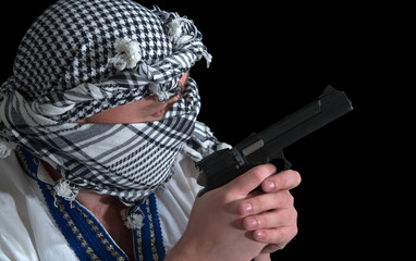 Man holding gun against black background