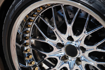 The chromeplated rim of a wheel