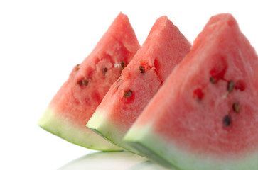 Greater pieces of a water-melon with seeds on a white background