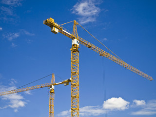 the building tower cranes at construction site