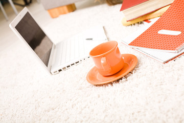 White laptop computer, books and exercise book